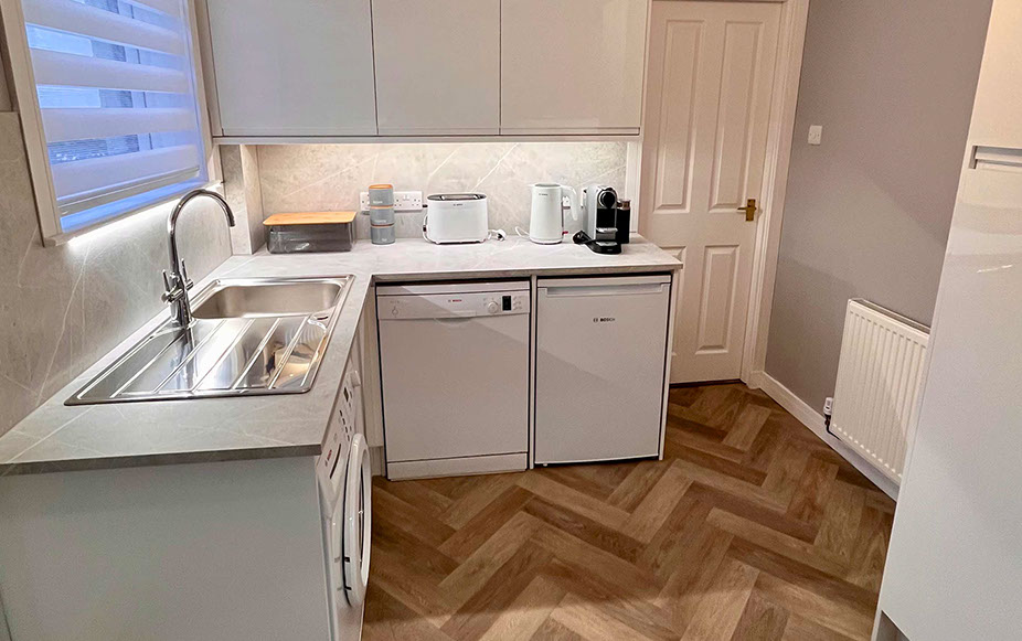 Glas Eilean View Dornie Self Catering contains a modern kitchen with Fridge and Microwave Toaster Kettle and Nespresso coffee machine 