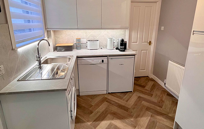 Glas Eilean View Dornie Self Catering contains a modern kitchen with Fridge and Microwave Toaster Kettle and Nespresso coffee machine 