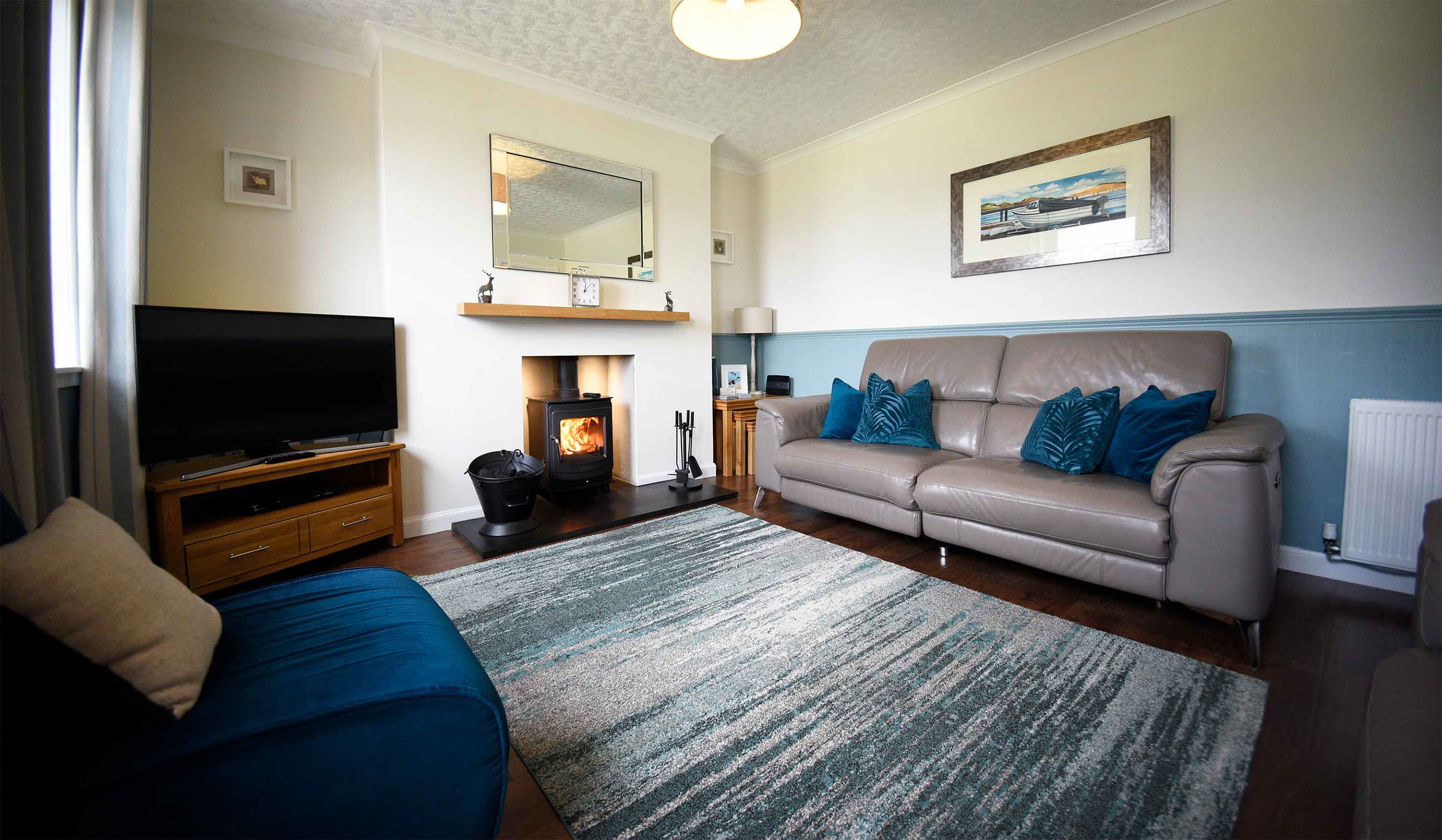 Glas Eilean View self catering living room with woodburning stove Smart TV Electric reclining seats and WIFI